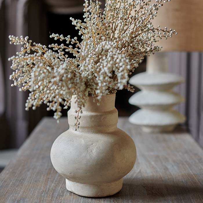 Sculptural paper mache vase in warm beige tones.