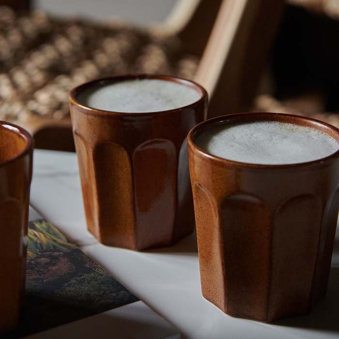 A closeup of the Franco Stoneware Mug - Set of 4 filled with coffee.