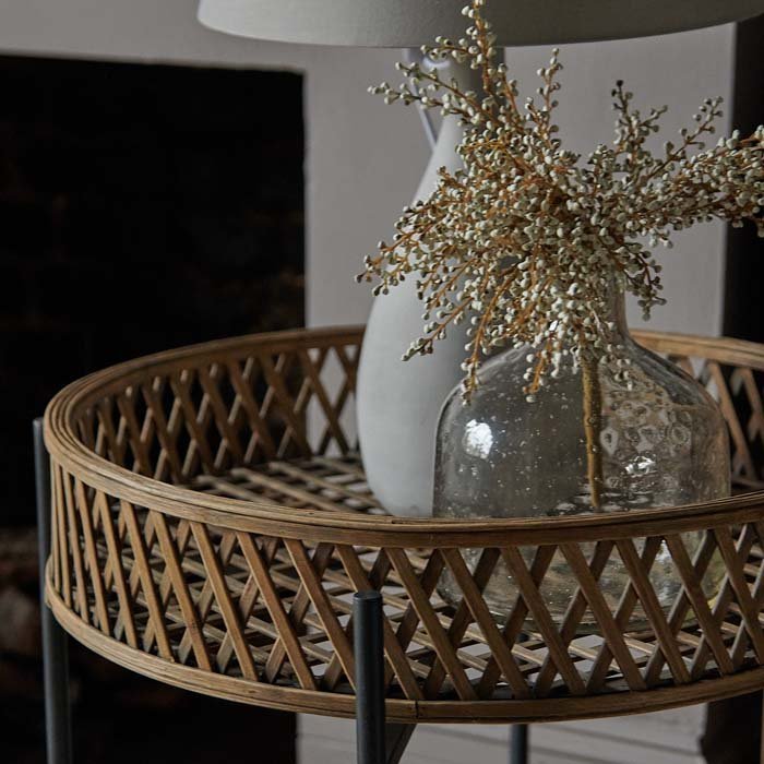 A closeup of a grey lamp on the top of the Marino Rattan Side Table.