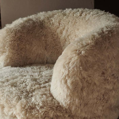 Soft, furry texture on a cream sheepskin armchair
