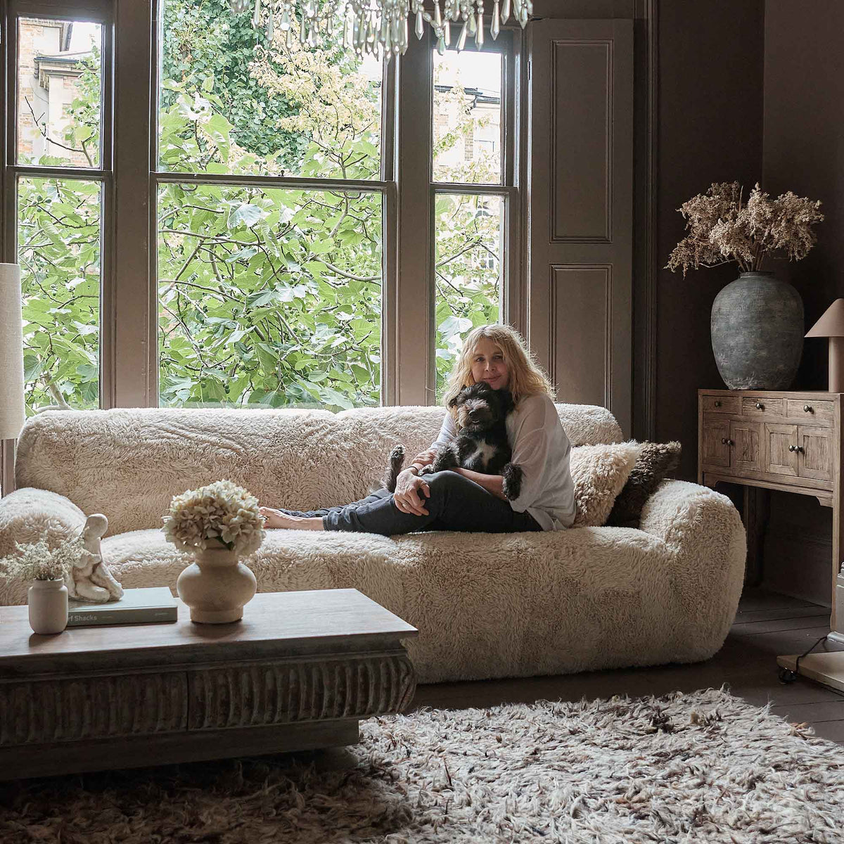 Cream faux sheepskin sofa with a plush textured finish, generous three seater design and deep comfortable cushioning. Saskia Sofa by Abigail Ahern, featuring a luxurious soft-touch upholstery and contemporary silhouette designed for relaxed lounging and stylish living spaces. A statement designer sofa perfect for modern living rooms and luxury interiors, adding warmth, texture and a cosy sophisticated feel to contemporary home decor.