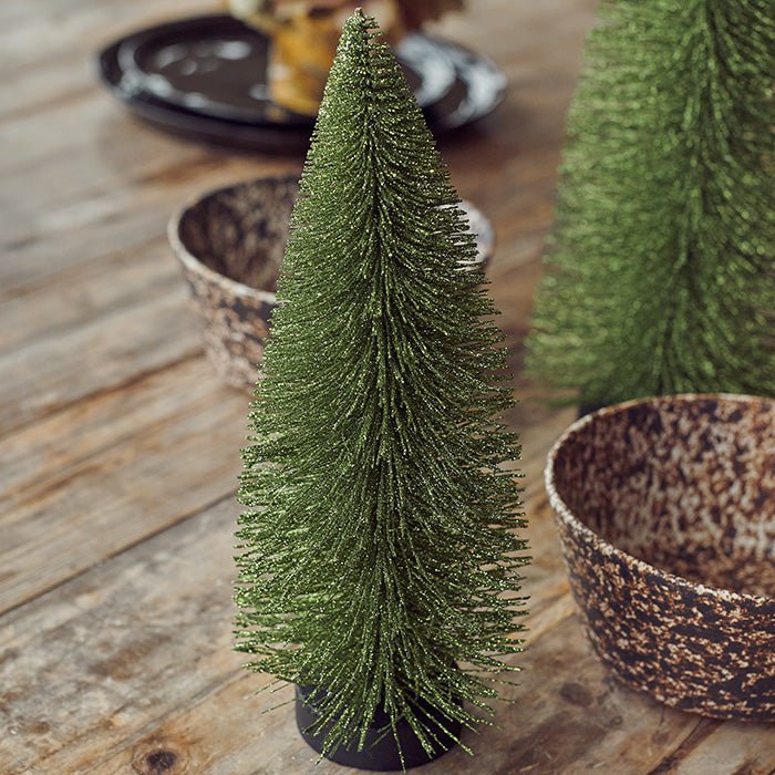 A decorative Christmas tree covered with gold sparkles.