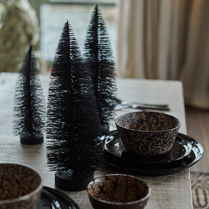 A festive decoration resembling a Christmas tree in black.