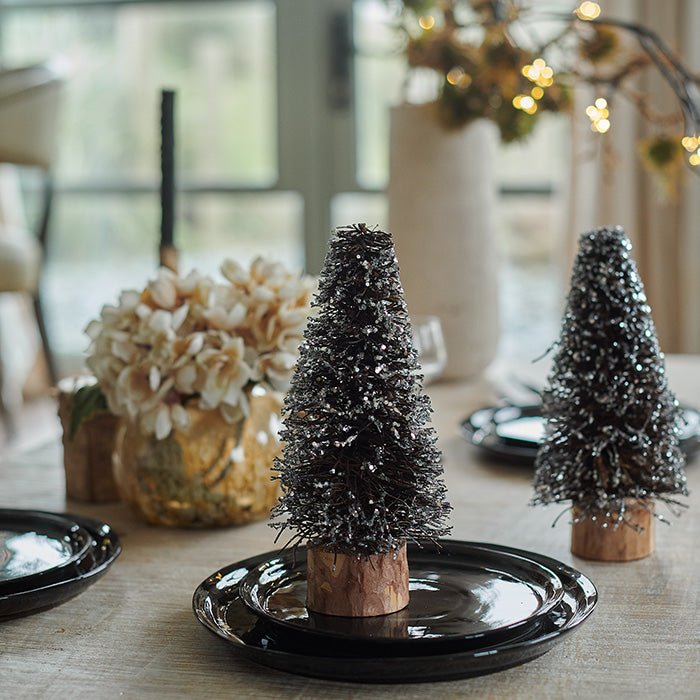 Small decorative Christmas trees covered in glitter.