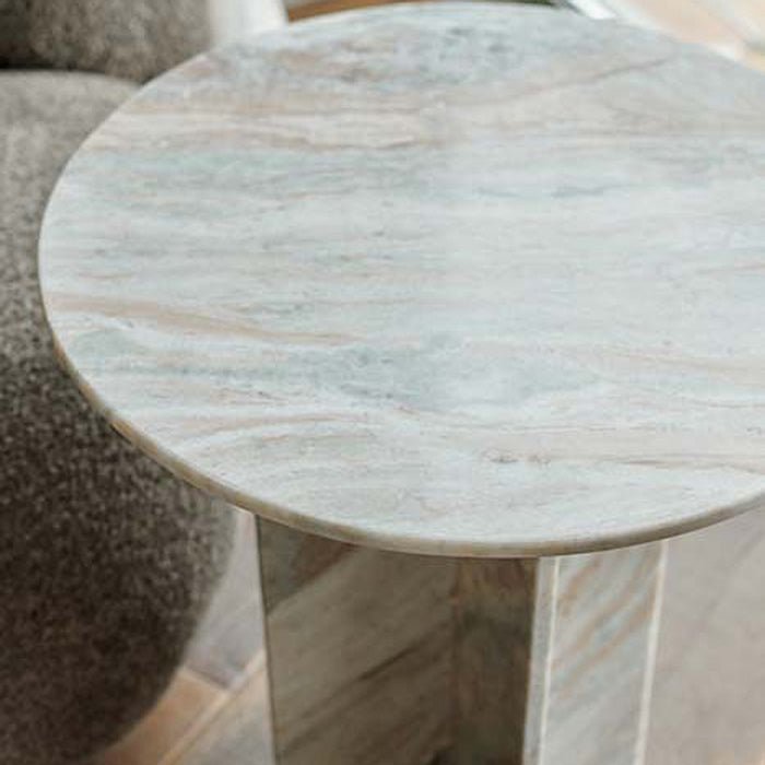 A closeup of the rich brown and grey hued marble surface of the Tortona Side Table.