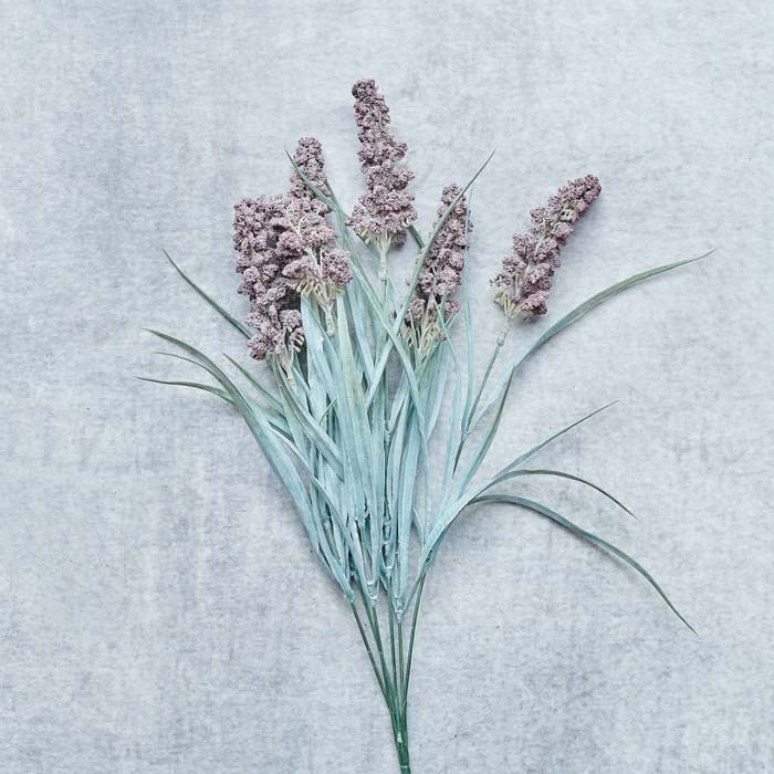 A single stem of faux lavender with purple flower heads and a pale green stem.