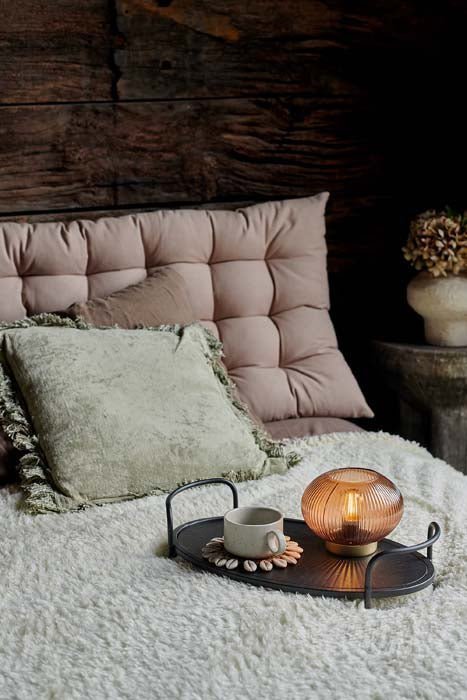 The Enrica Headboard Cushion, a sumptuous padded rectangular headboard cushion in putty coloured cotton, pictured on a cosy bed.