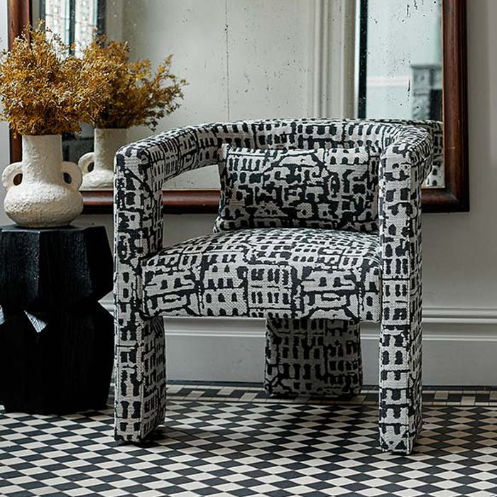 Black and white patterned armchair with a distinctive abstract print, upholstered linen blend fabric and contemporary three-legged silhouette. Bushwick Patterned Armchair by Abigail Ahern, designed as a statement accent chair for modern living rooms, bedrooms, dining spaces and home offices. A luxury occasional chair that adds character, texture and bold designer style to contemporary interiors.