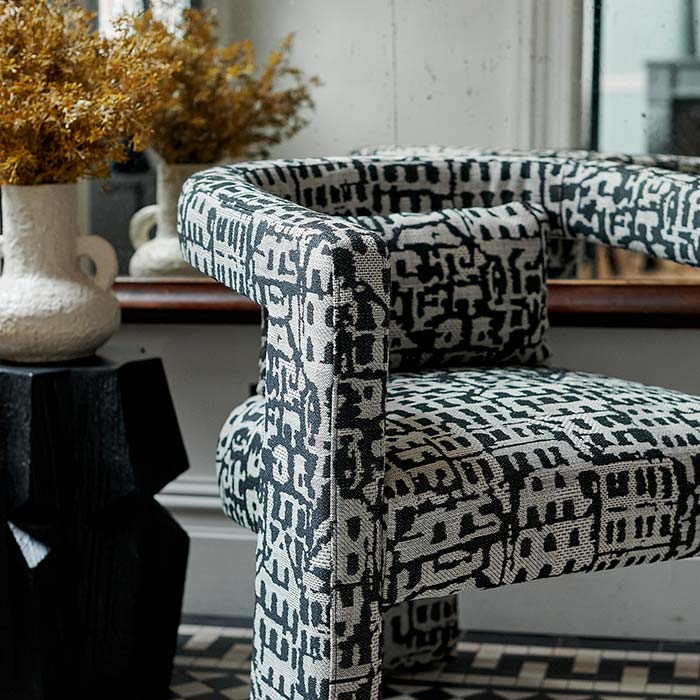 A closeup of the abstract patterned fabric on the Bushwick Occasional Chair.