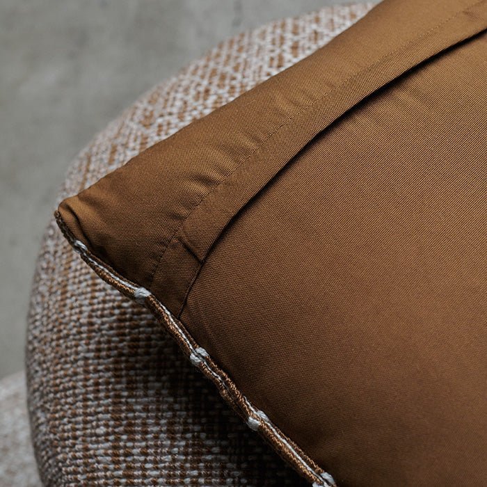 A closeup of the rich earthy brown plain back of the Soriano Cushion.