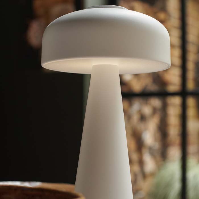 Detail image of the curved dome top and modern base of a white rechargeable table lamp.
