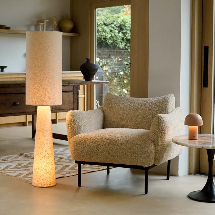 Cream boucle armchair with a soft textured fabric finish, comfortable cushioned seat and contemporary structured silhouette. Belville Armchair by Abigail Ahern, crafted in a luxurious boucle upholstery designed to create a cosy and stylish focal point in modern interiors. A statement accent chair perfect for living rooms, bedrooms and dining spaces, adding warmth, texture and timeless elegance to luxury home decor.