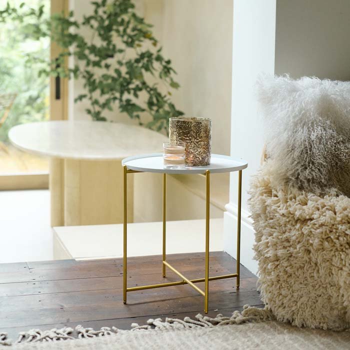 The Sandford Side Table - White, a small round side table with a white tray top and slim gold coloured folding legs.