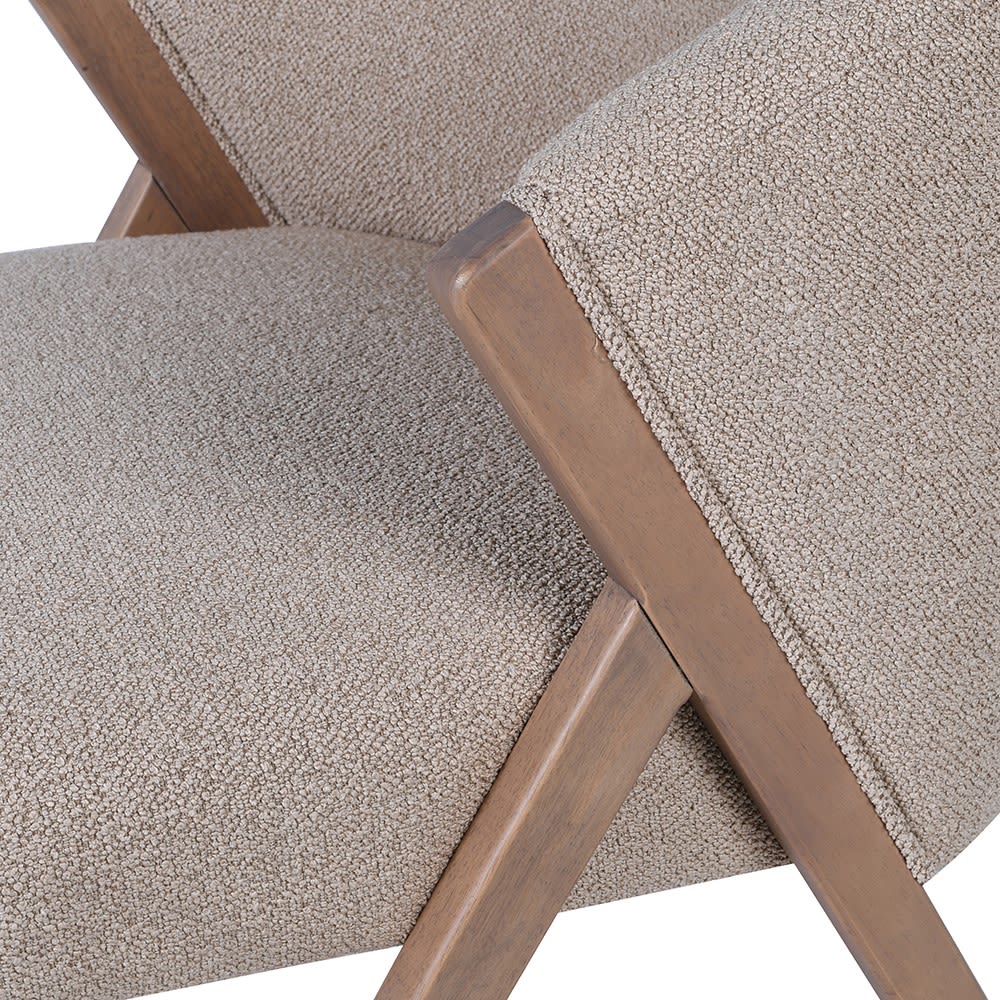 Close-up of the Abigail Ahern Lyndon Dining Chair showcasing its softly curved upholstered back, deep cushioning and natural rubberwood frame.