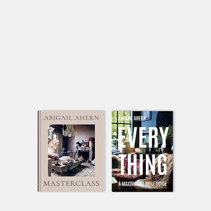 Cutout image on a white background of two hardback books by Abigail Ahern with images of her interiors.
