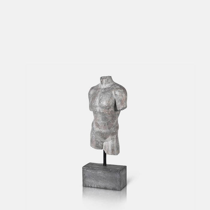 A cutout of the Adonis Scultpure, a polyresin model of a male torso with a faux metal finish mounted on a small plinth.