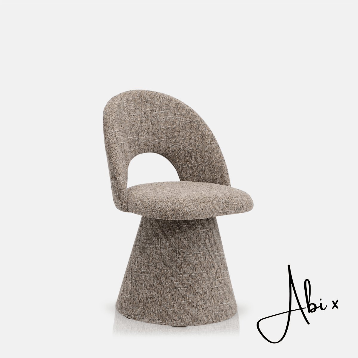 Contemporary upholstered, comfortable dining chair in a textured grey fabric featuring a sculptural curved silhouette a modern but organic design for stylish dining interiors.