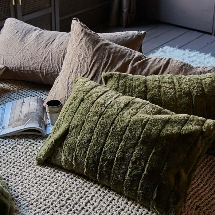 The Alayna Faux Fur Cushion, a rectangular faux fur cushion in a mossy green hue with ridged stitched detailing.