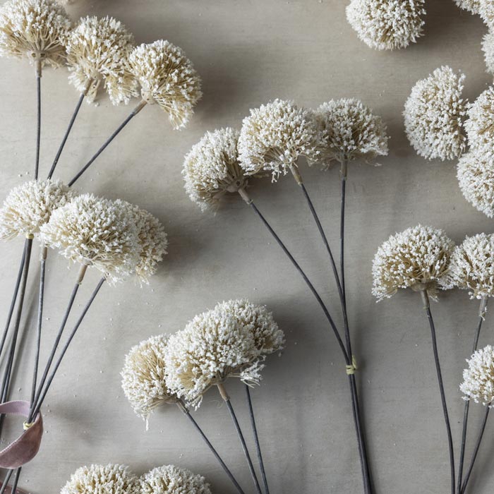 Luxury artificial allium flower stem. White round spiky flowers that add lifelike texture to vases. Realistic faux flower stem to add a natural look to flower bouquets. Luxury artificial flowers that look lifelike from Abigail Ahern known for boundary pushing designs.