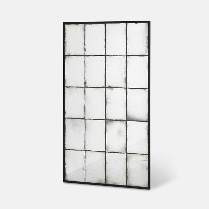 A cutout of the Aslan Mirror, a tall window pane effect mirror with antique looking glass and a thin black frame.