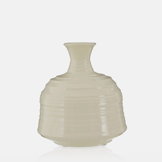 Cutout image of a small, cream vase with a ribbed texture, perfect for holding small a faux bouquet