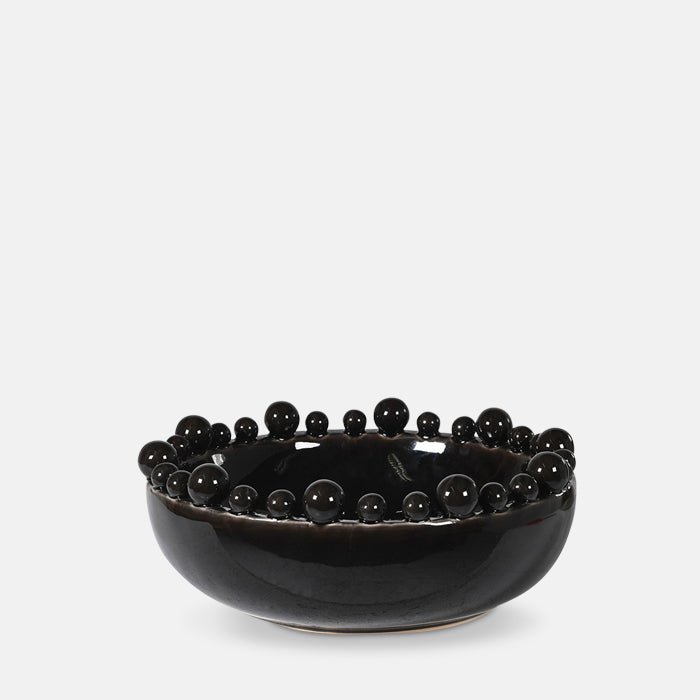 A cutout of the Bourton Bowl - Black, a large round bowl with a glossy glazed finish and textural bubble top.