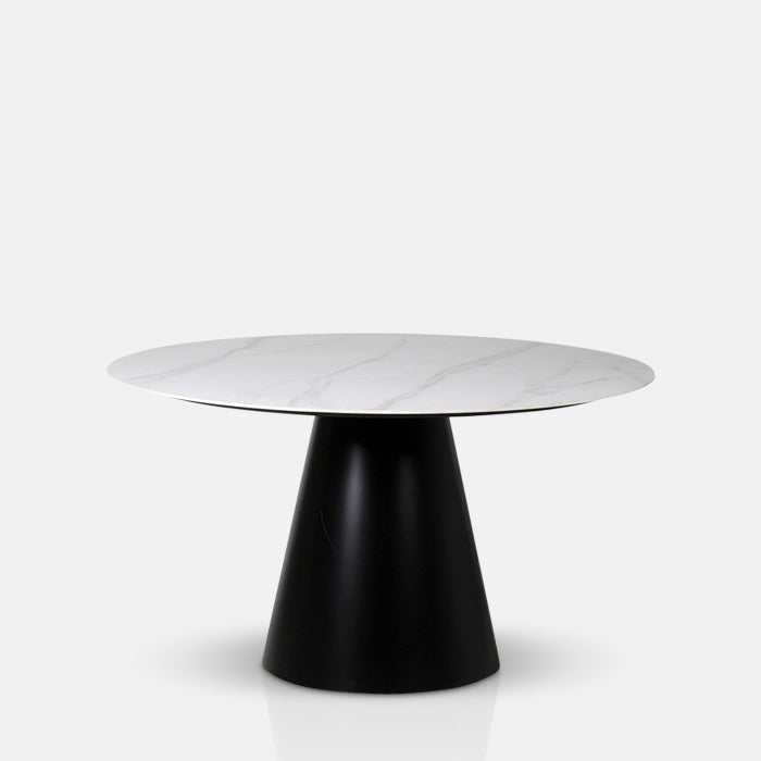 A cutout of the Caldwell Dining Table. A round faux carrara marble top on a chunky black metal base table.