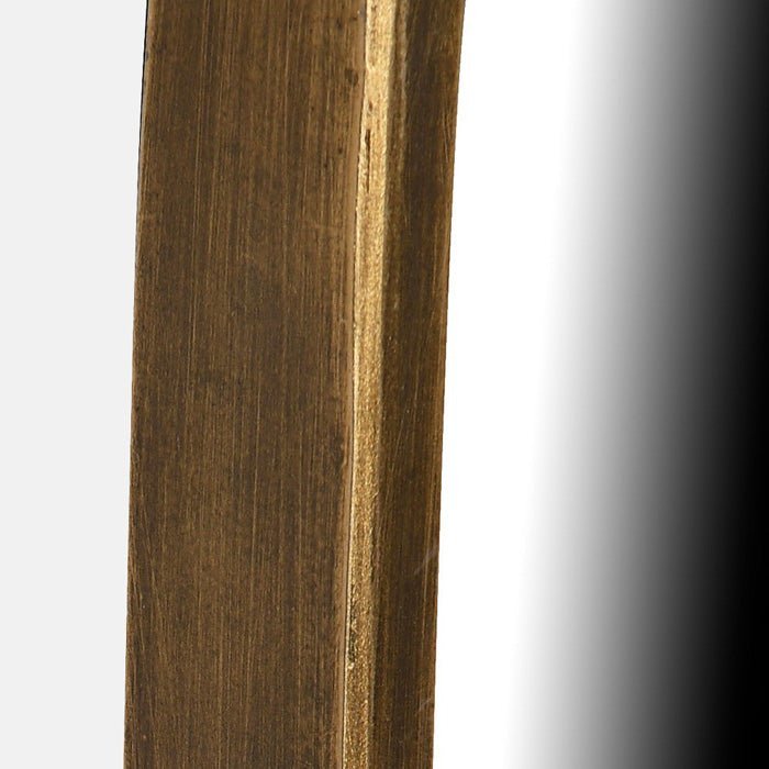 A closeup of the slim gold iron frame of the Casper Mirror - Large.
