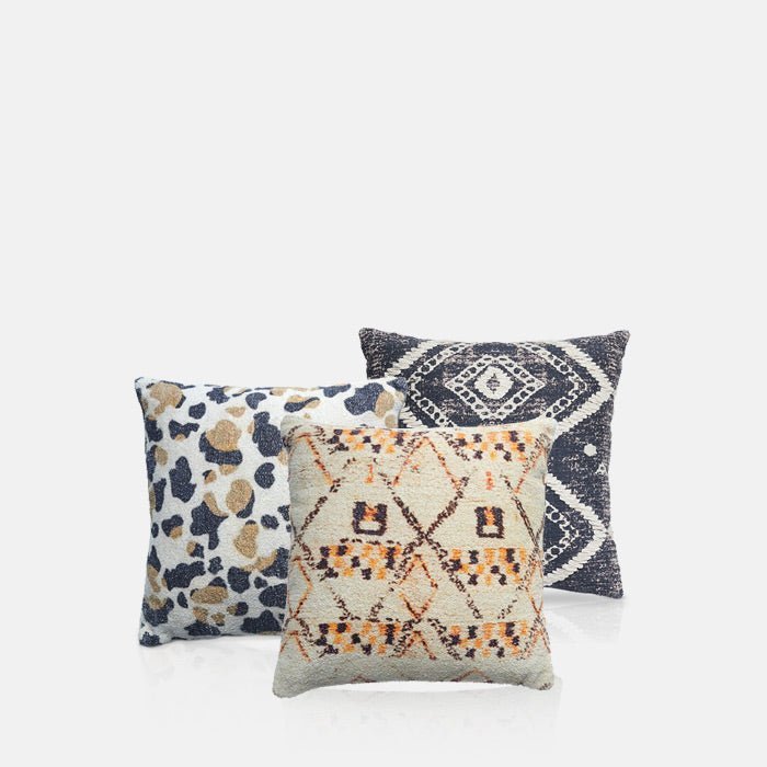 A cutout of 3 cushions with unique patterns. Abigail Ahern unique home accessories.