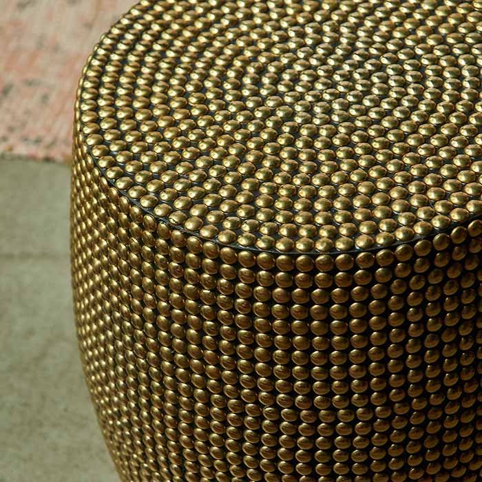 A closeup showing the brass stud detailing on the Dewitt Brass Stud Stool.