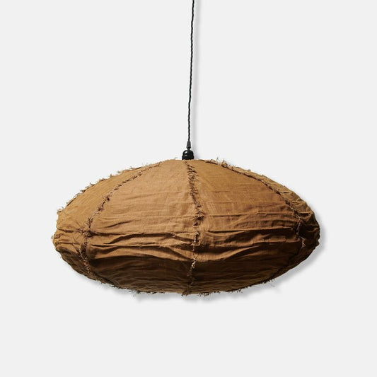 A cutout of an oval fabric lampshade in caramel hued linen. Trusted in interiors since 2003, Abigail Ahern for unique homeware.