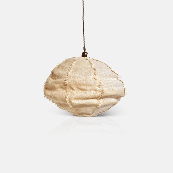 A cutout of a small fabric pendant lampshade in a cream colour with textured seams. Abigail Ahern trusted in interiors for 20 years.