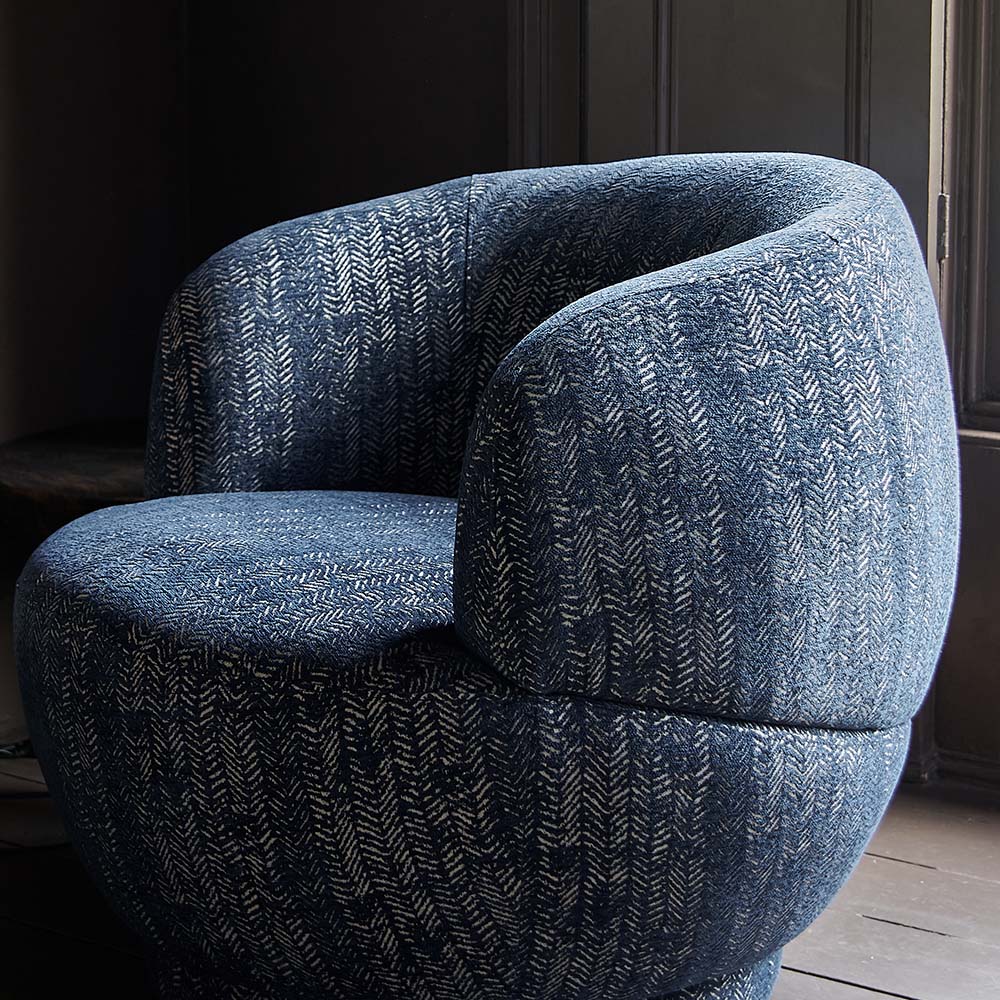 A side view of the navy herringbone pattern on the Elliot Occasional Chair.