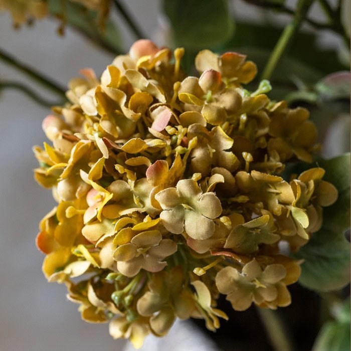 Detail image of the fabric flowers that are on the artificial guelder rose stems.