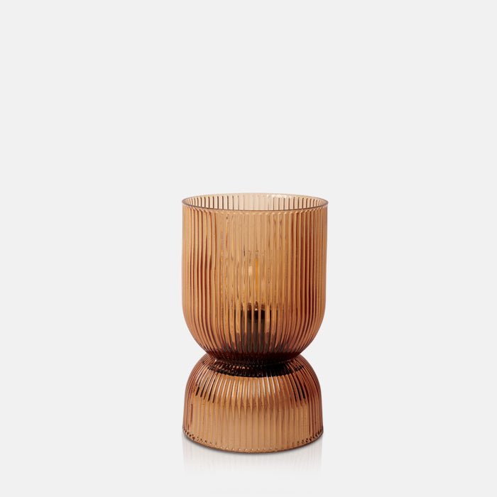 Hourglass shaped, cordless led lamp in a ribbed amber glass