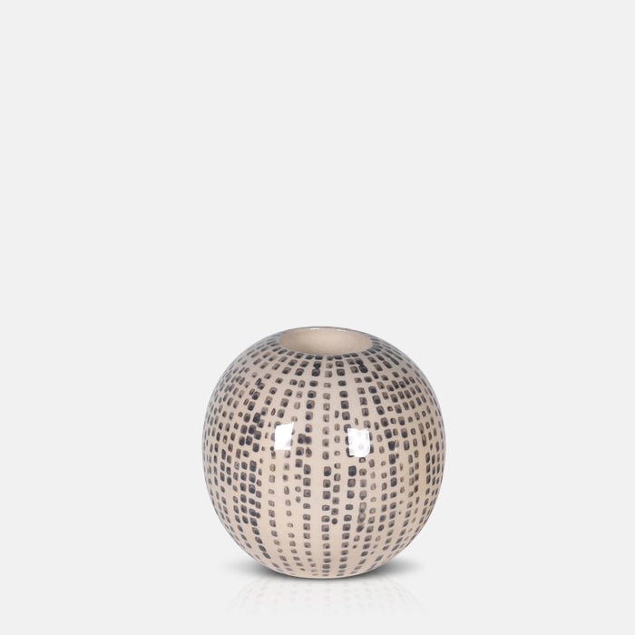 Spherical cream candleholder with a brown dotted pattern