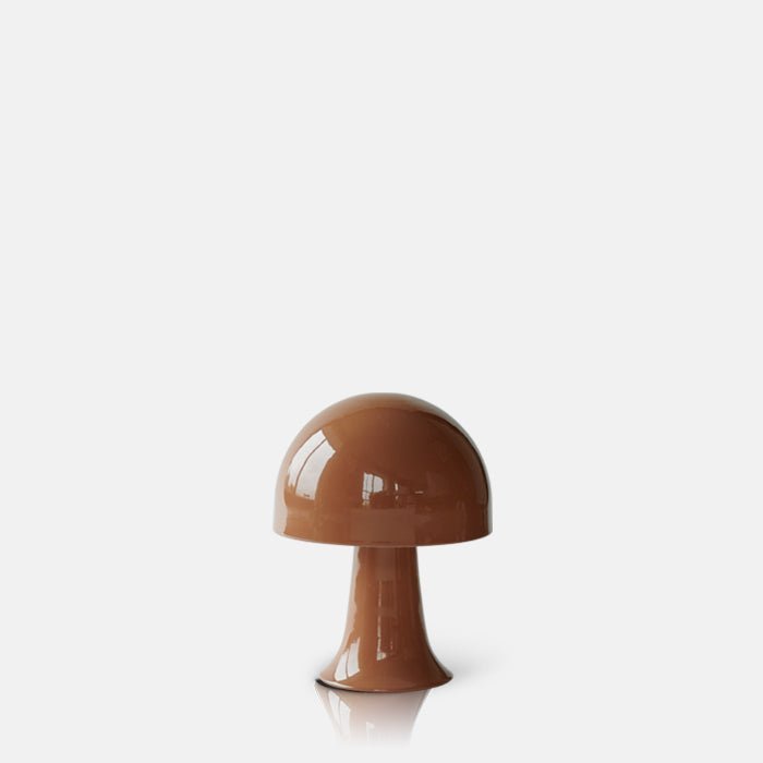 A cutout of the Julio LED Lamp by Abigail Ahern, known for her rule breaking designs and stylish interiors. A close up of a small portable LED table lamp in colourway called sepia which is a soft brown terracotta hue.These small curvy lamps are super flexible to pop all over. the house, style next to your bath, bedside or create intrigue to your tablescapes and a dash of colour to your kitchen worktops.