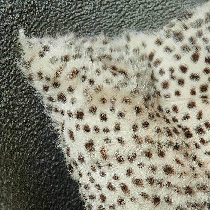 A closeup of the leopard print design on the goat fur front of the Kampala Leopard Print Cushion.
