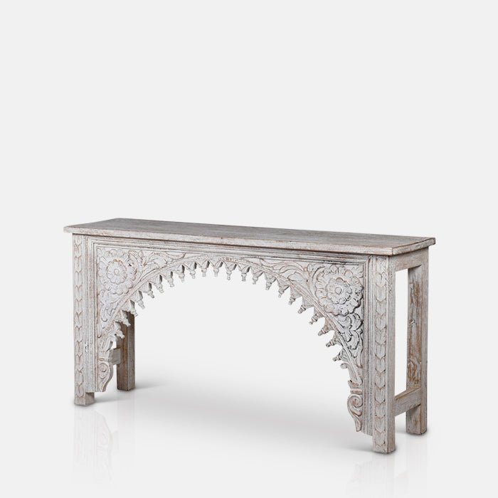 A cutout of the Karnata Carved Console, a slimwooden console with an elaborately carved arched front design.