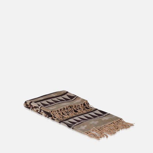 Brown and purple patterned throw with tassel fringe.