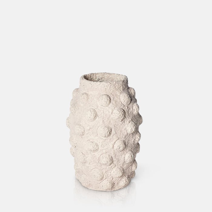 Cutout image on a white background of a large cement vase with a bobble texture in a beige finish.