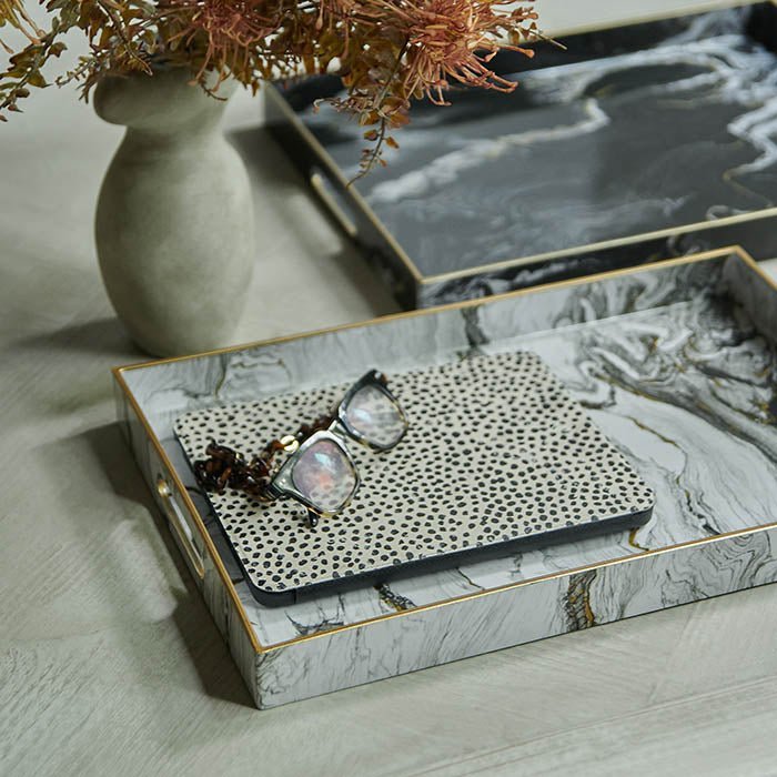 Magnus Trays - Set of 2, a set of two marble effect trays in two colorways black and white with brass details.