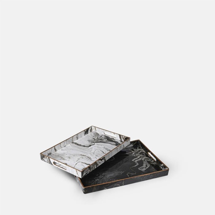 Cutout of the Magnus Trays - Set of 2. A set of two marble effect trays in two colorways black and white with brass details.