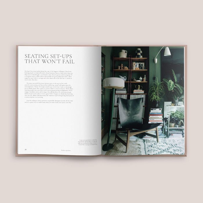 Masterclass, an A4 sized hardcover book, opened to show a picture of a stylish lounge room in dark tones.