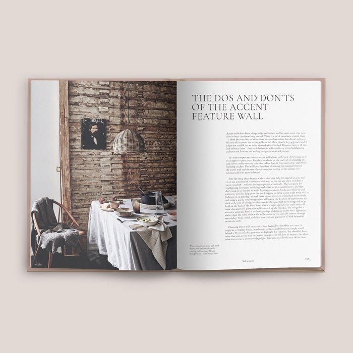 Masterclass, an A4 sized hardcover book, opened to show a picture of a dining table decorated in neutral toned accessories.