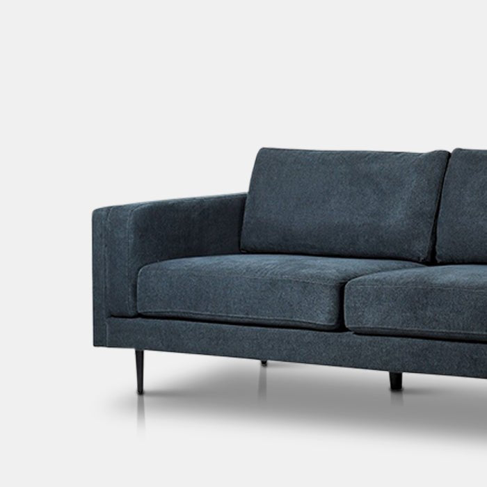 The Medford 3 Seater Sofa, an angular design sofa in a deep inky blue velvet.