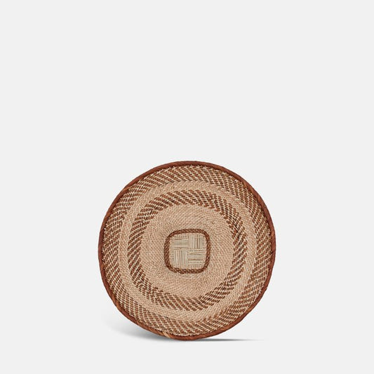 Round wall basket with natural and dark brown ring pattern design.
