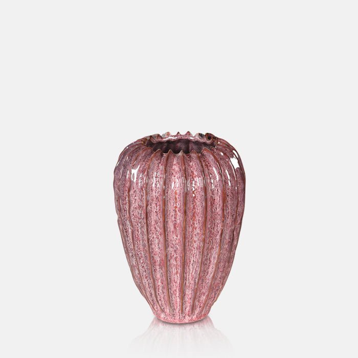 A cutout of the Mollie Ceramic Vase. A rective glazed ceramic vase with a ribbed texture in a dark pink hue.