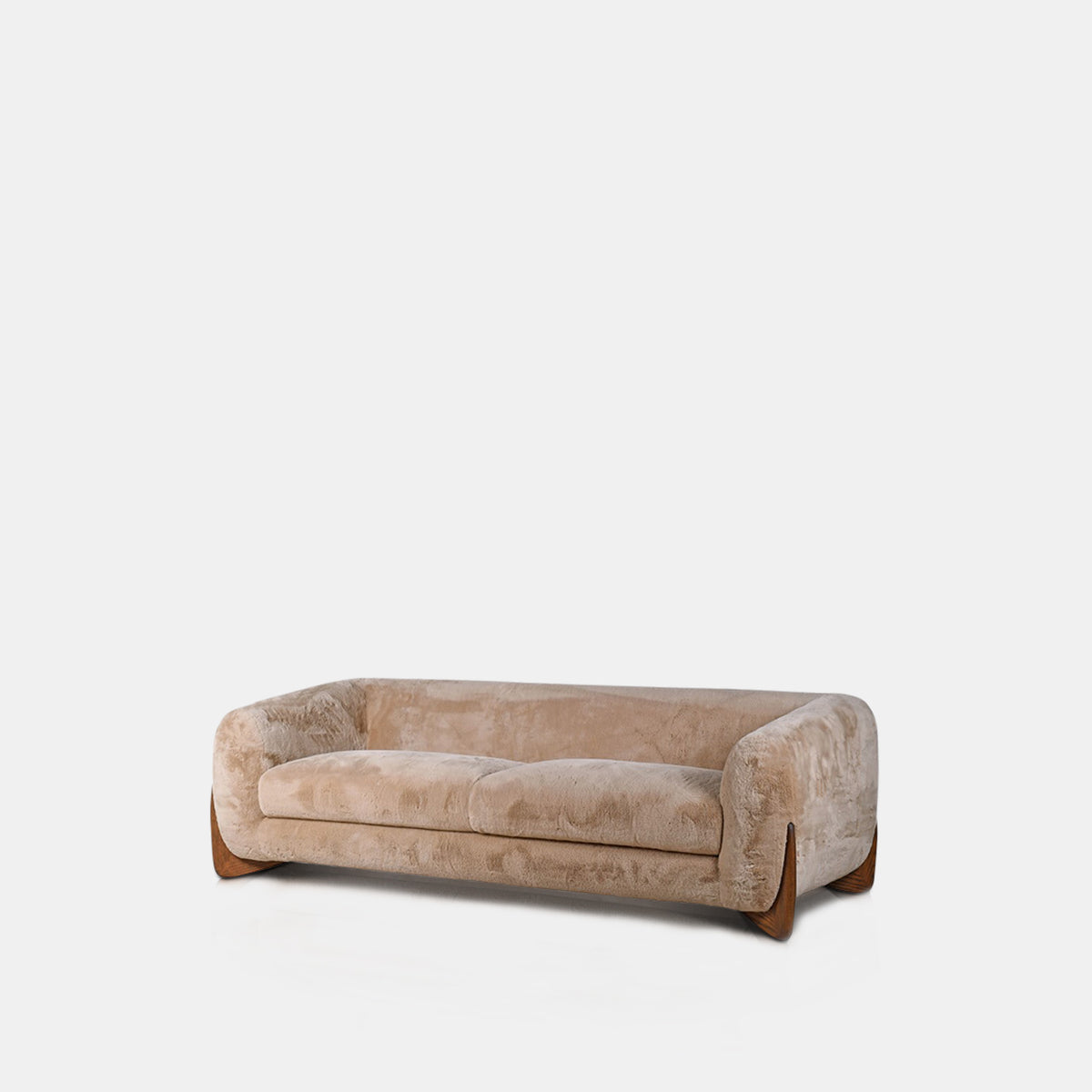 Cream faux sheepskin sofa with a soft tactile texture, rounded mid-century inspired silhouette and warm oak wooden legs. Moritz Faux Sheepskin Sofa by Abigail Ahern, designed with a generous three seater shape and deep comfortable cushioning for relaxed everyday lounging. A luxury statement sofa perfect for modern living rooms and contemporary interiors, adding cosy texture, timeless style and a sophisticated focal point to your home decor.