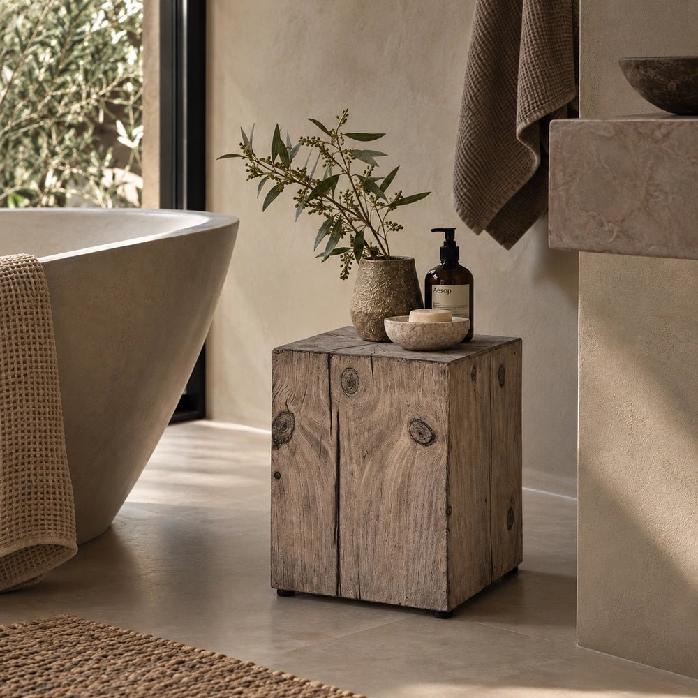 Norton Stool styled in a warm neutral room setting, with its compact rounded seat, realistic wood-effect finish and sculptural curved legs clearly visible.
